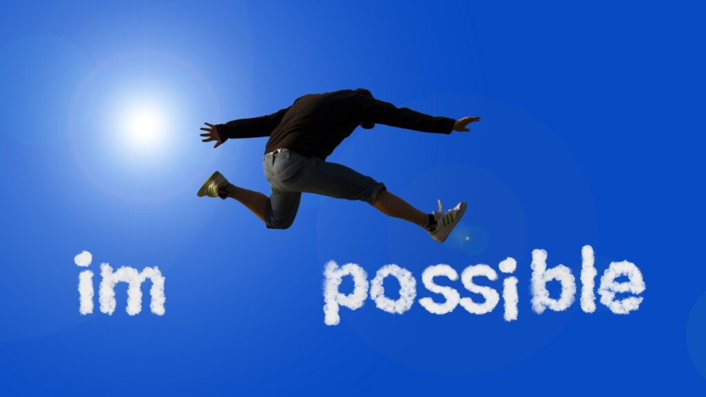 Un homme saute de “im” à “possible” pour former le mot “possible”, symbole d’un changement de perspective